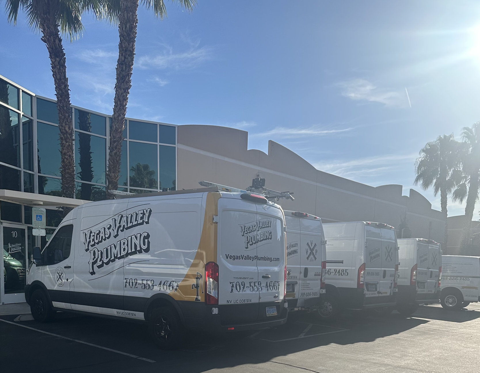 Vegas Valley Plumbing - Trucks in parking lot Vegas Valley Plumbing